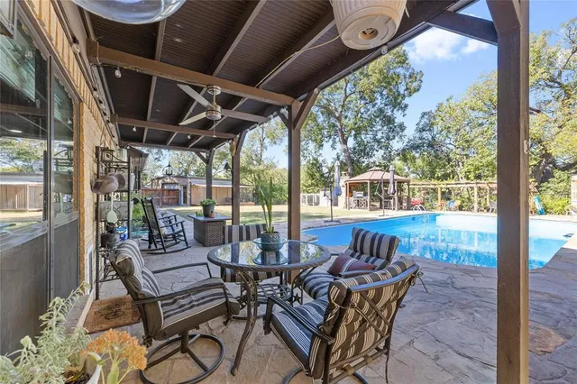 a patio with table and chairs