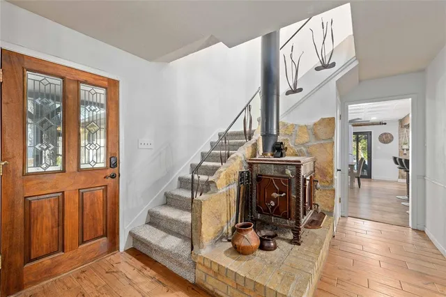 a view of entryway livingroom and hall with wooden floor
