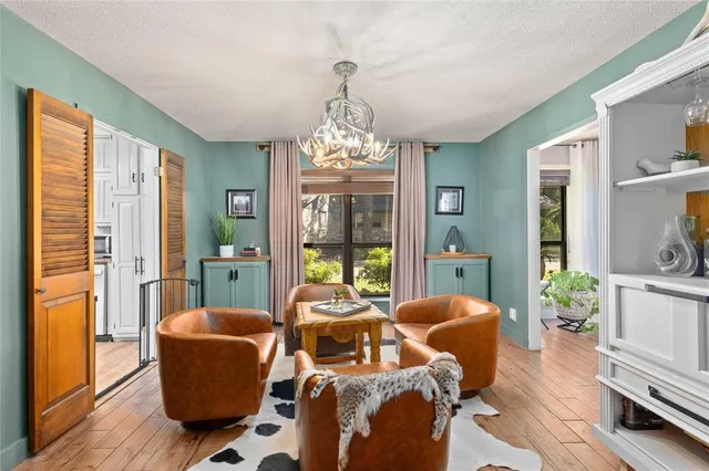 a living room with furniture and a chandelier