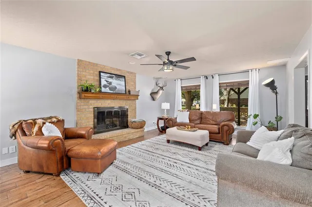 a living room with furniture fireplace and window