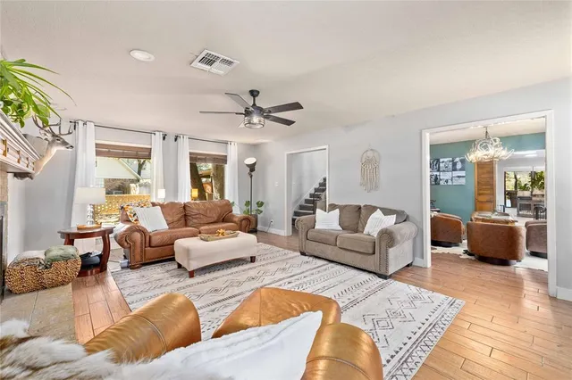 a living room with furniture and view of kitchen