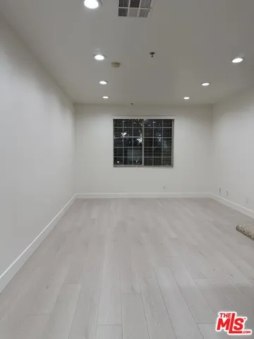 an empty room with a empty space and windows