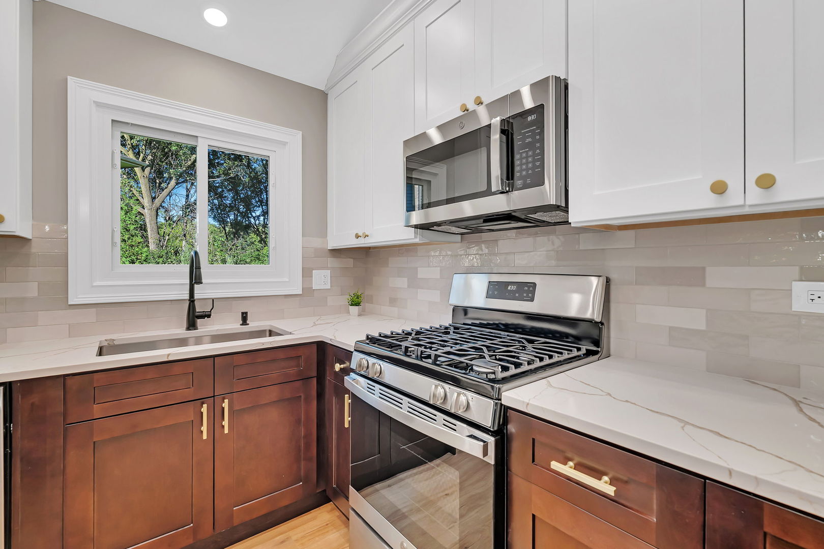1520 Lighthouse Drive Naperville, IL 60565 - Photo 14 of 36 a kitchen with stainless steel appliances granite countertop a sink a stove microwave and cabinets
