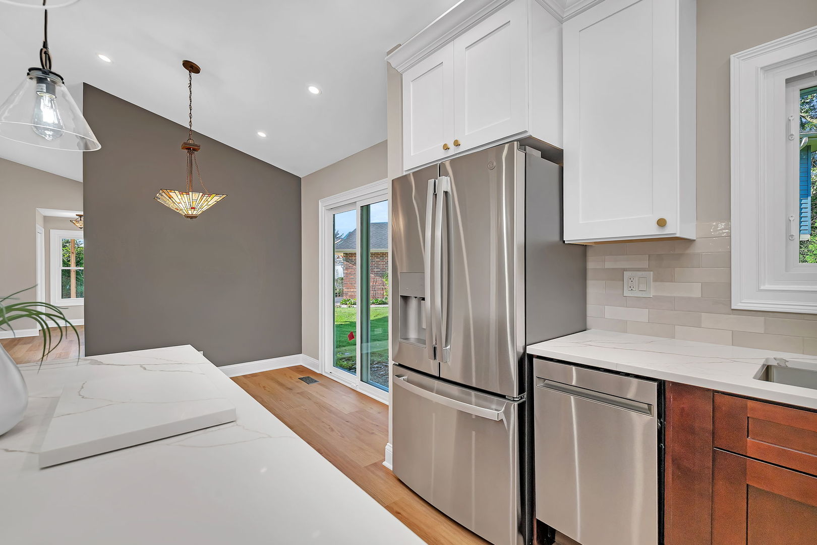 1520 Lighthouse Drive Naperville, IL 60565 - Photo 15 of 36 a kitchen with stainless steel appliances granite countertop a refrigerator a sink and white cabinets