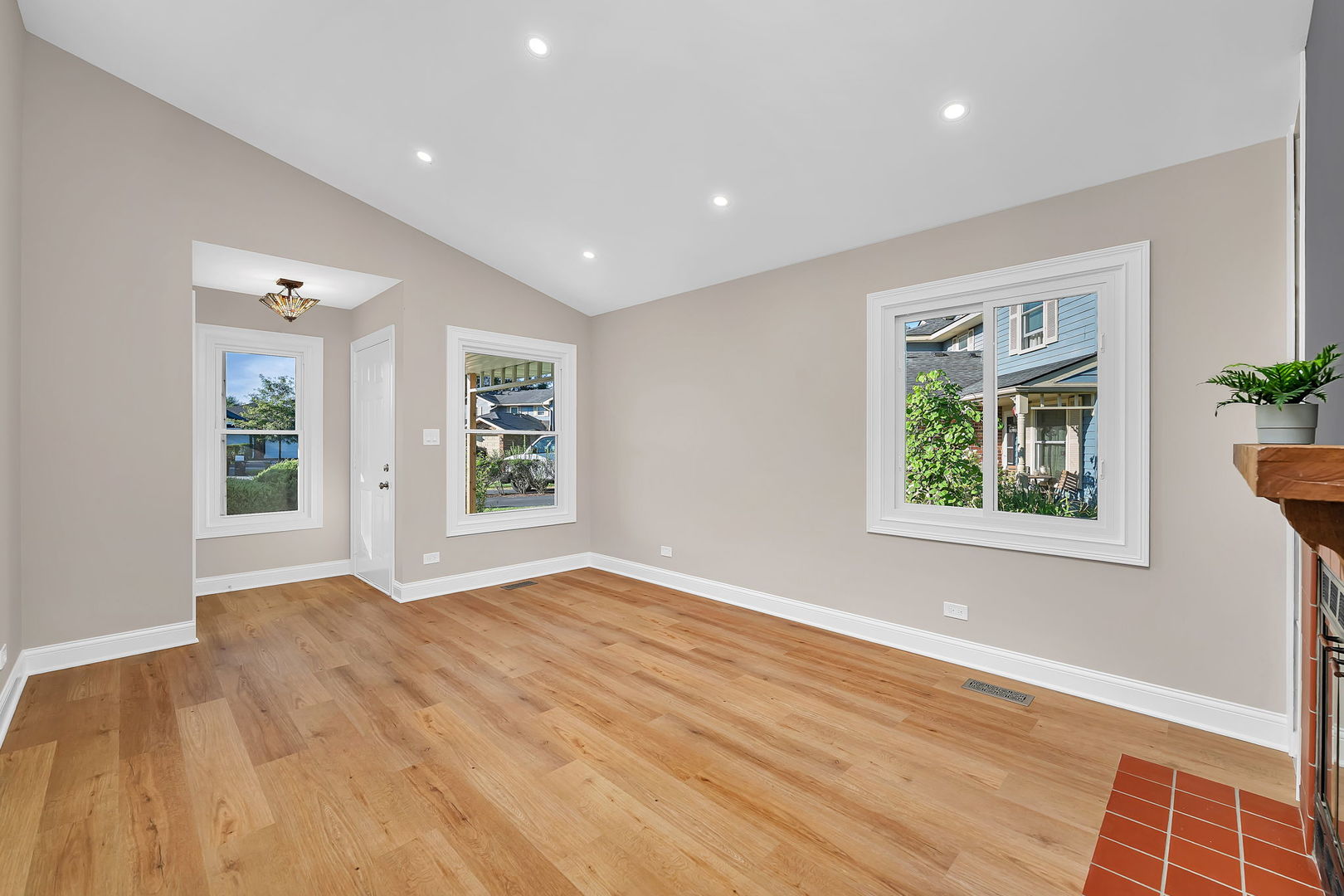 1520 Lighthouse Drive Naperville, IL 60565 - Photo 6 of 36 a view of an empty room with a window and wooden floor