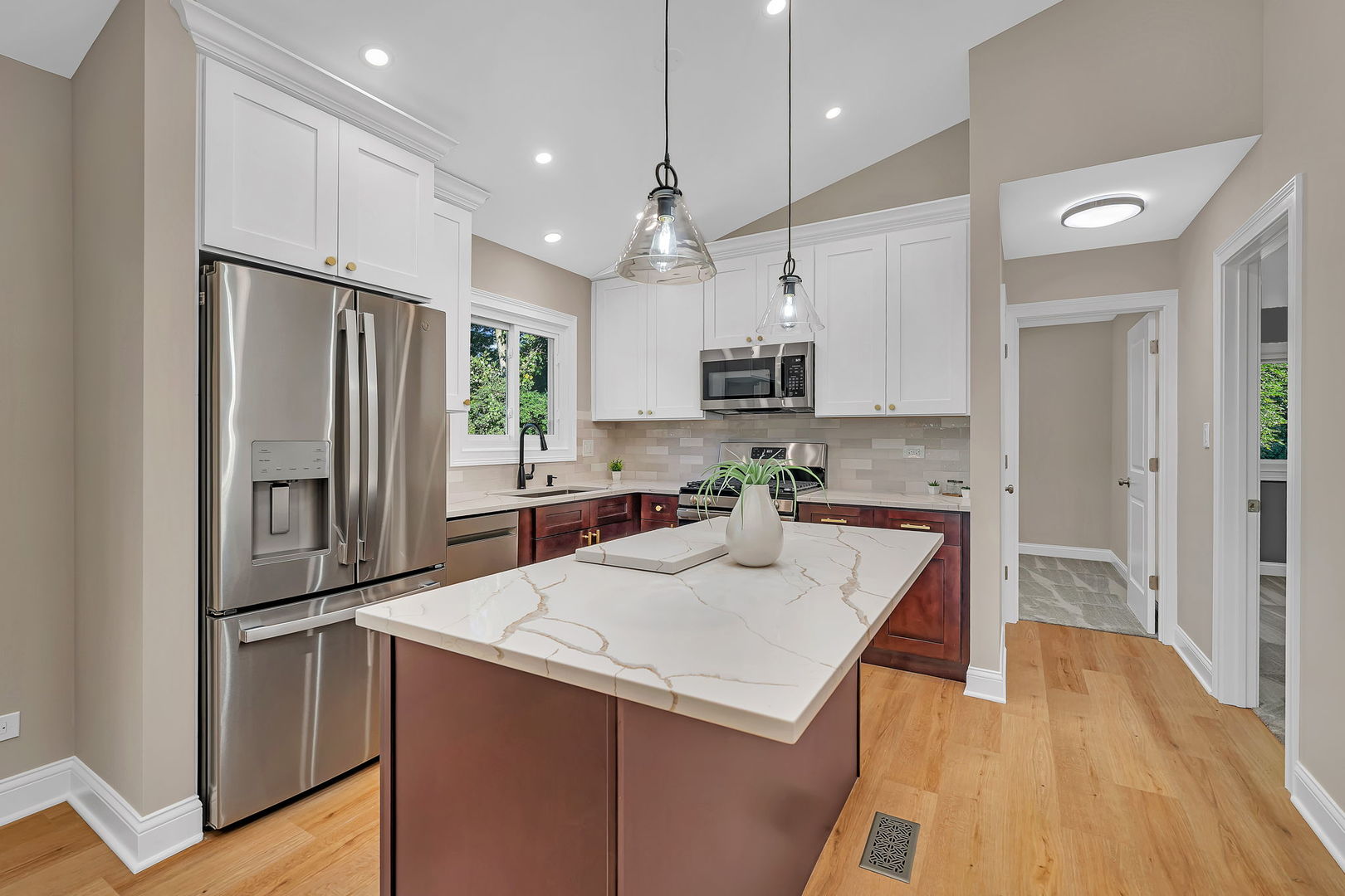 1520 Lighthouse Drive Naperville, IL 60565 - Photo 10 of 36 a kitchen with kitchen island granite countertop a sink refrigerator and microwave
