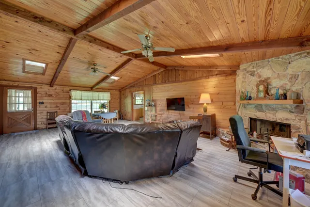 a living room with furniture a fireplace and a table