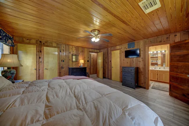 a bed room with a bed and a television