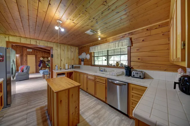 a kitchen with stainless steel appliances granite countertop sink stove and cabinets