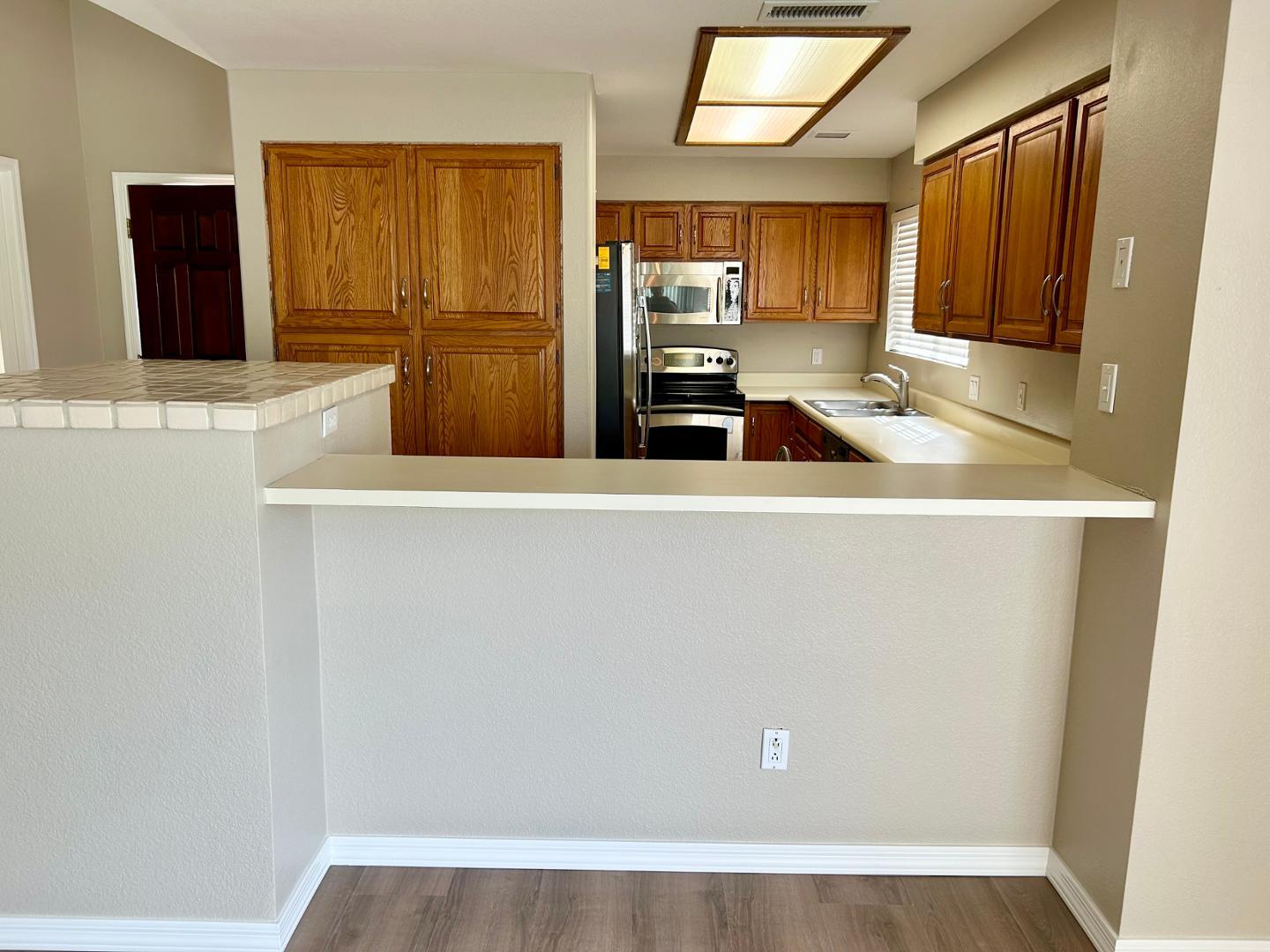 10015 East Mountain View Road, Unit 2009 Scottsdale, AZ 85258 - Photo 8 of 18 a view of a kitchen with refrigerator and wooden cabinets