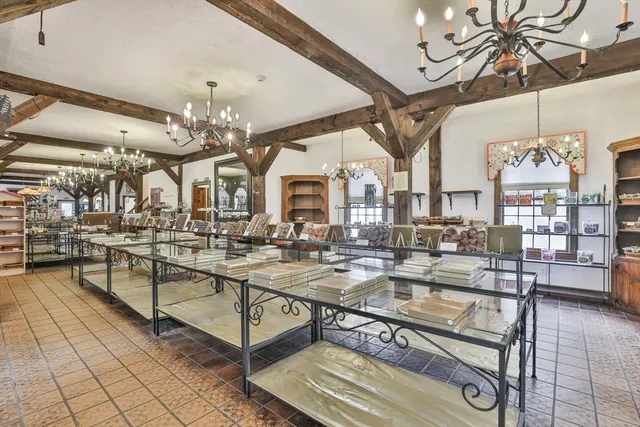a living room with lots of furniture and chandelier