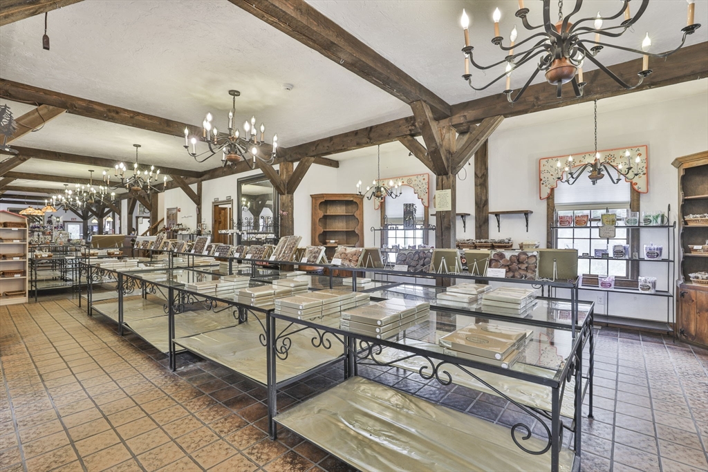 47 Sugar Road Bolton, MA 01740 - Photo 14 of 42 a living room with lots of furniture and chandelier