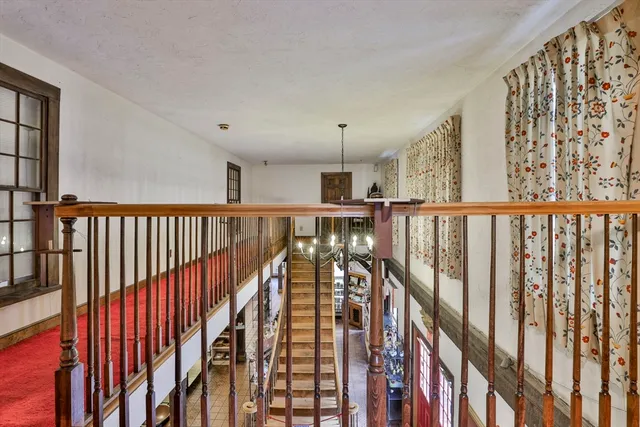 a view of a hallway with wooden floor and entryway