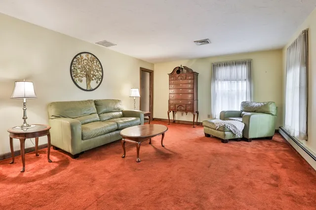 a living room with furniture and a lamp