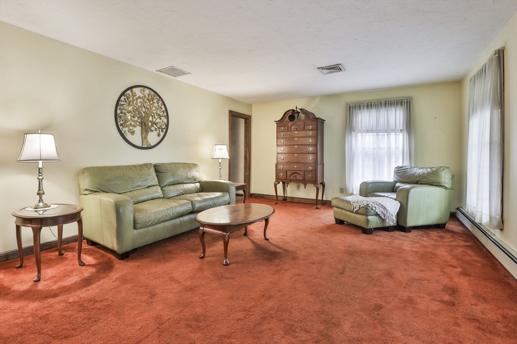 47 Sugar Road Bolton, MA 01740 - Photo 24 of 42 a living room with furniture a clock and a window