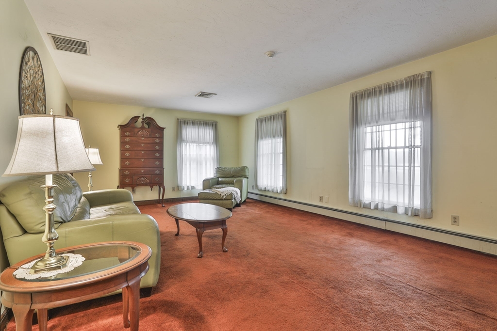47 Sugar Road Bolton, MA 01740 - Photo 25 of 42 a living room with furniture and a lamp