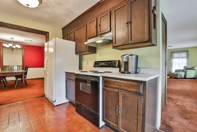 a view of a hallway with closet and a large window