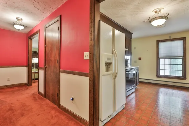 a kitchen with stainless steel appliances granite countertop a stove a sink dishwasher and a refrigerator with wooden cabinets