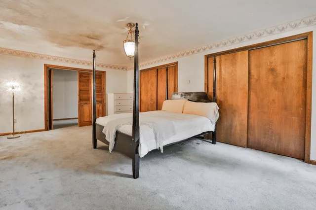 a bed room with a bed and a chandelier