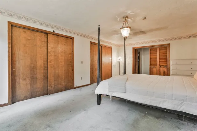 a view of a bedroom with closet and balcony