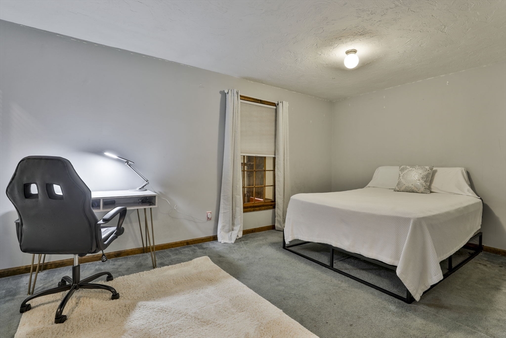 47 Sugar Road Bolton, MA 01740 - Photo 39 of 42 a bedroom with a bed a desk and chair