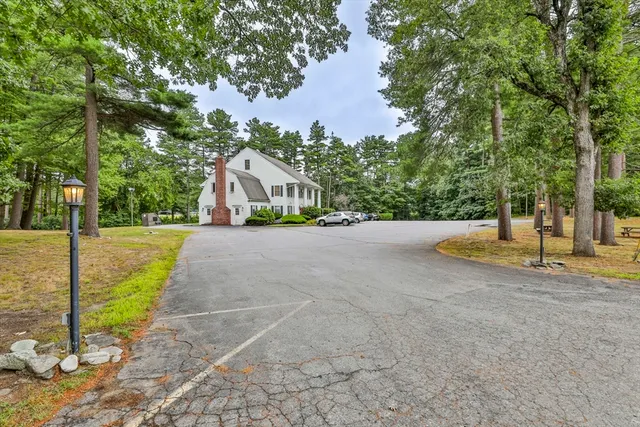 a view of a house with backyard and tree