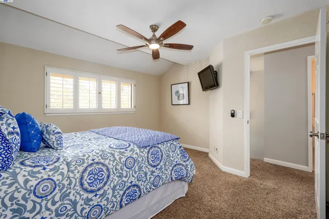 a bedroom with a large bed and a window