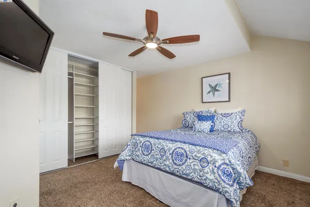 a bedroom with a large bed and a flat screen tv