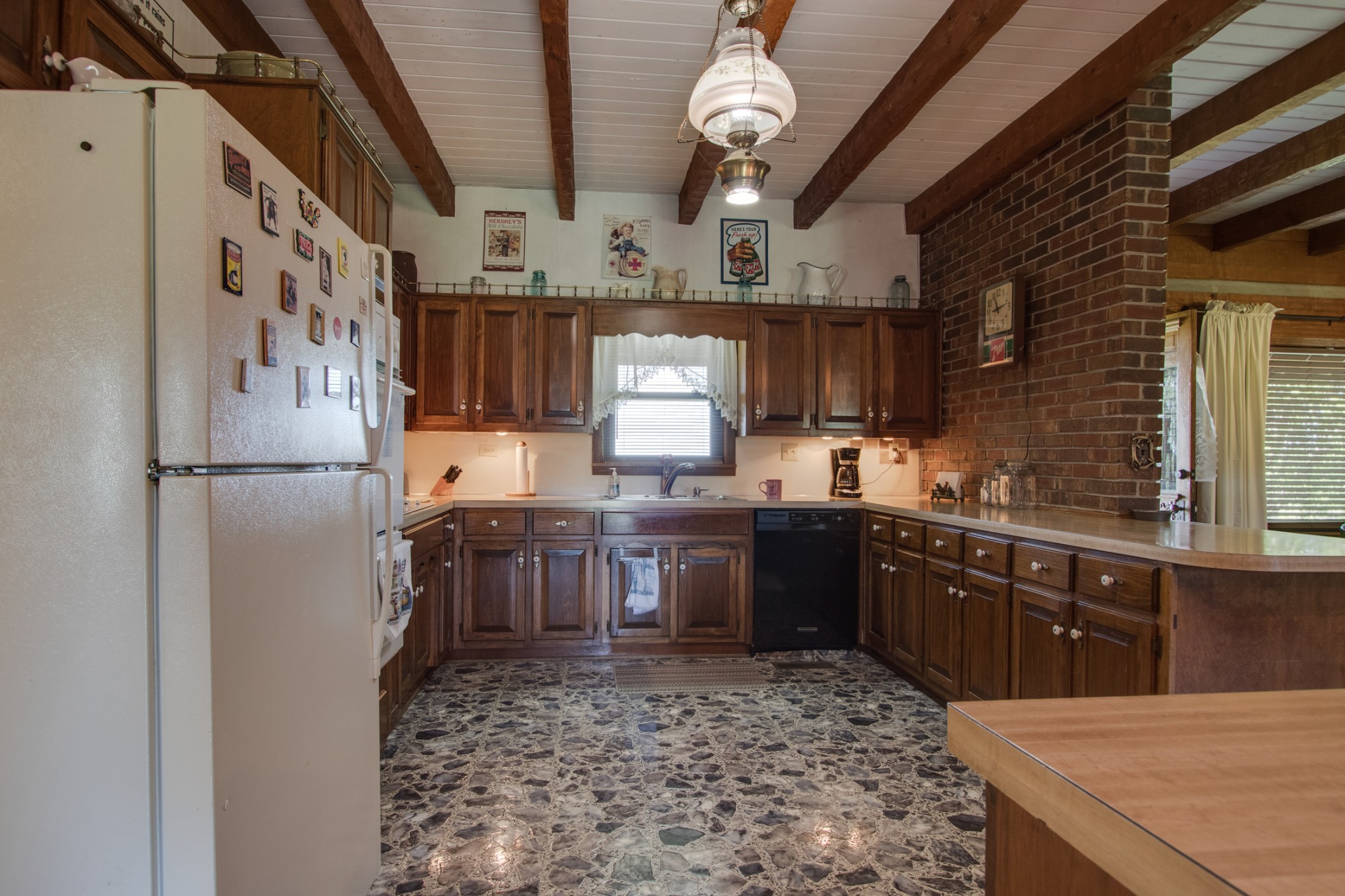 25 Cages Bend Lane Riddleton, TN 37151 - Photo 32 of 50 a kitchen with granite countertop a refrigerator a sink dishwasher a stove and a dining table with wooden floor