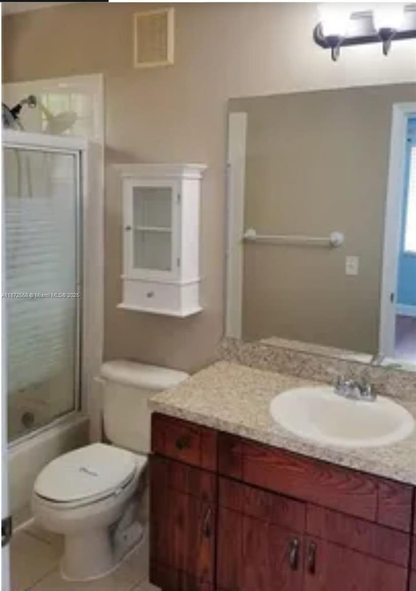 4345 Northwest 69th Terrace, Unit 4345 Lauderhill, FL 33319 - Photo 16 of 20 a bathroom with a granite countertop sink toilet and shower