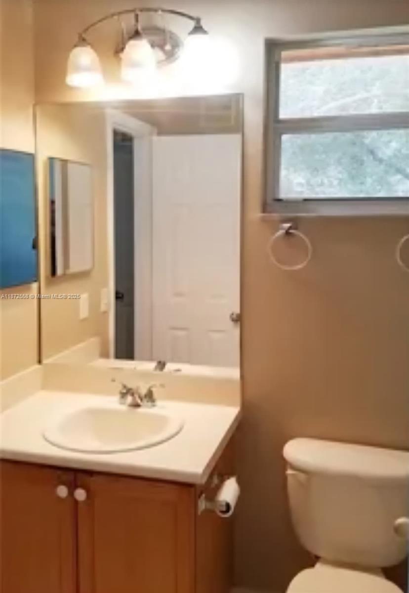 4345 Northwest 69th Terrace, Unit 4345 Lauderhill, FL 33319 - Photo 18 of 20 a bathroom with a sink and a mirror