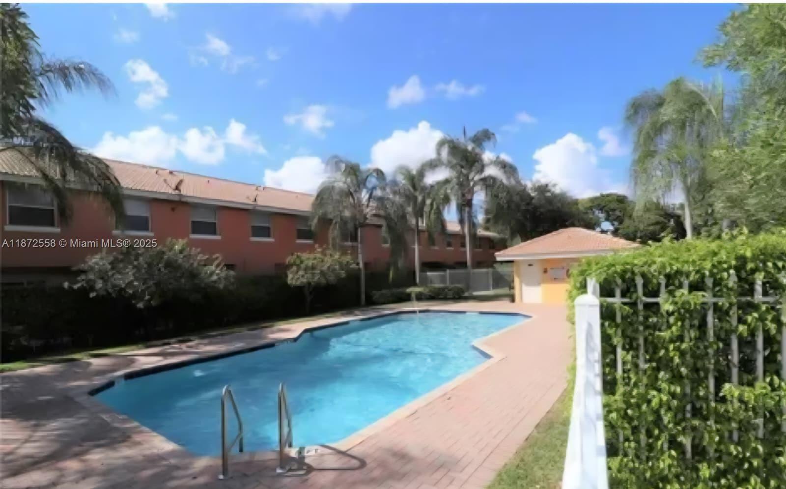 4345 Northwest 69th Terrace, Unit 4345 Lauderhill, FL 33319 - Photo 20 of 20 a front view of a house with yard and green space