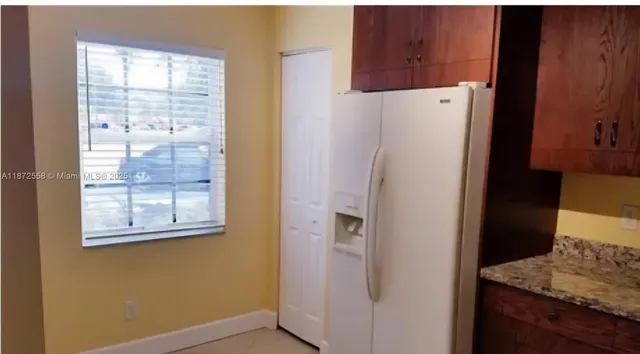 a white refrigerator freezer sitting inside of a kitchen