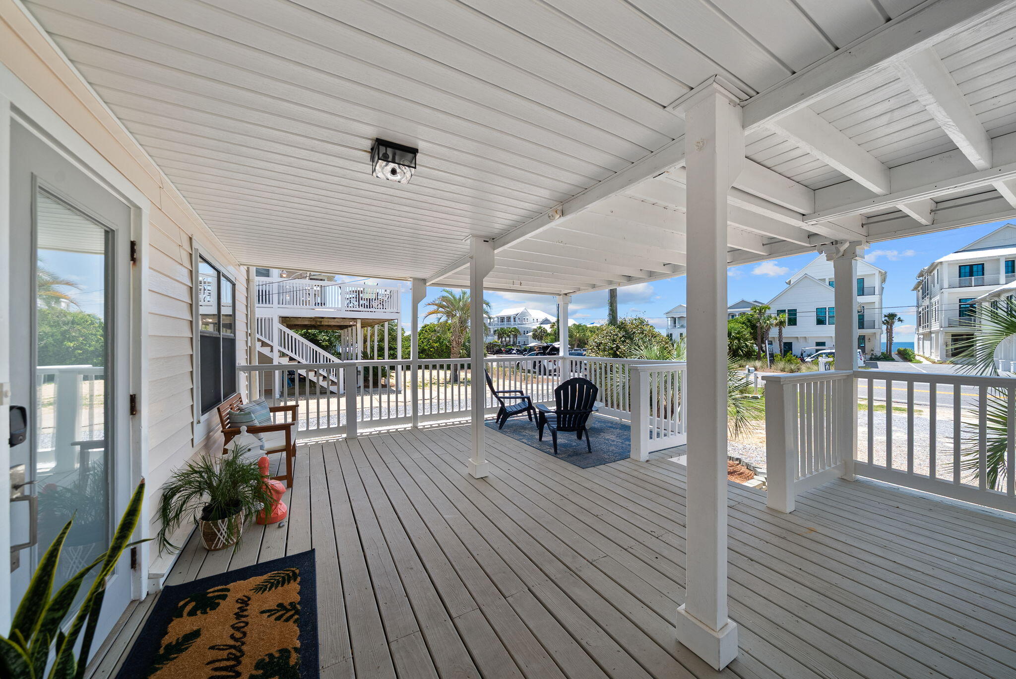 8009 East County Highway 30A Inlet Beach, FL 32461 - Photo 18 of 56 a view of a patio with table and chairs potted plants with wooden floor