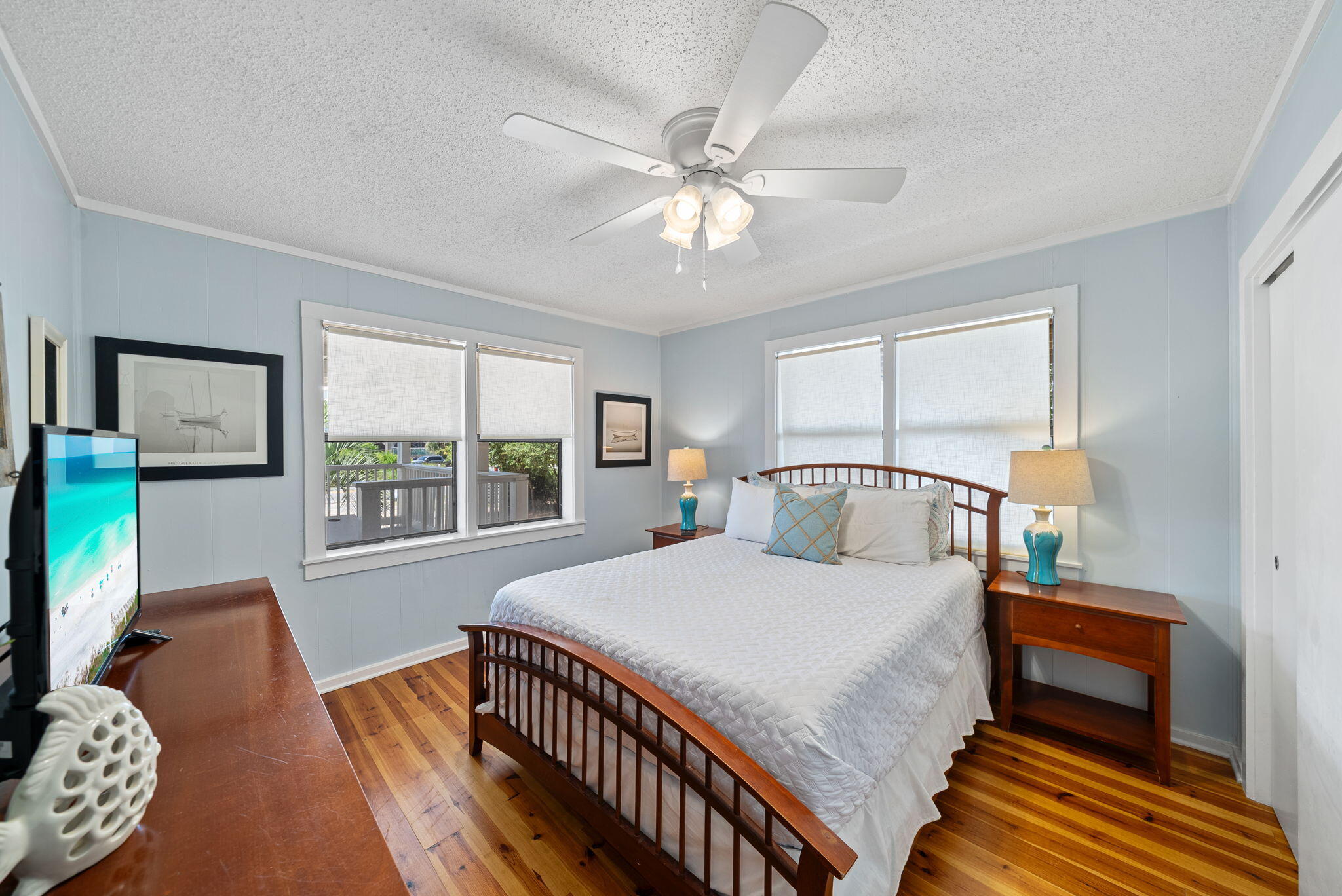 8009 East County Highway 30A Inlet Beach, FL 32461 - Photo 19 of 53 a bedroom with a bed a flat screen tv and a large window with the outer view