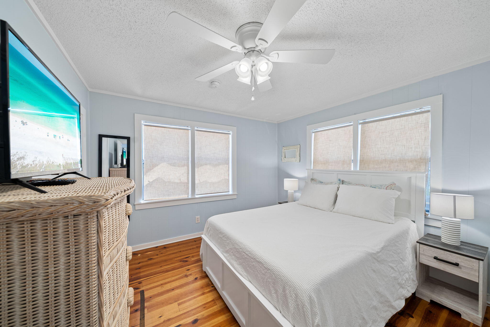 8009 East County Highway 30A Inlet Beach, FL 32461 - Photo 24 of 56 a bedroom with a large bed and a flat tv screen on dresser