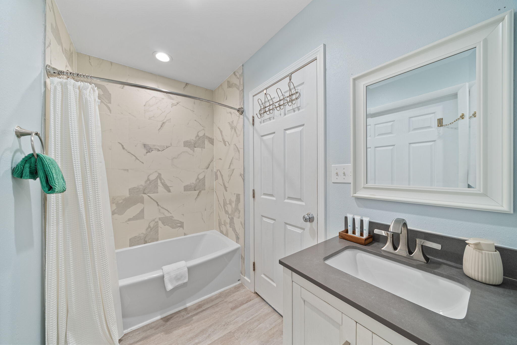 8009 East County Highway 30A Inlet Beach, FL 32461 - Photo 28 of 53 a bathroom with a granite countertop bathtub a sink and a mirror
