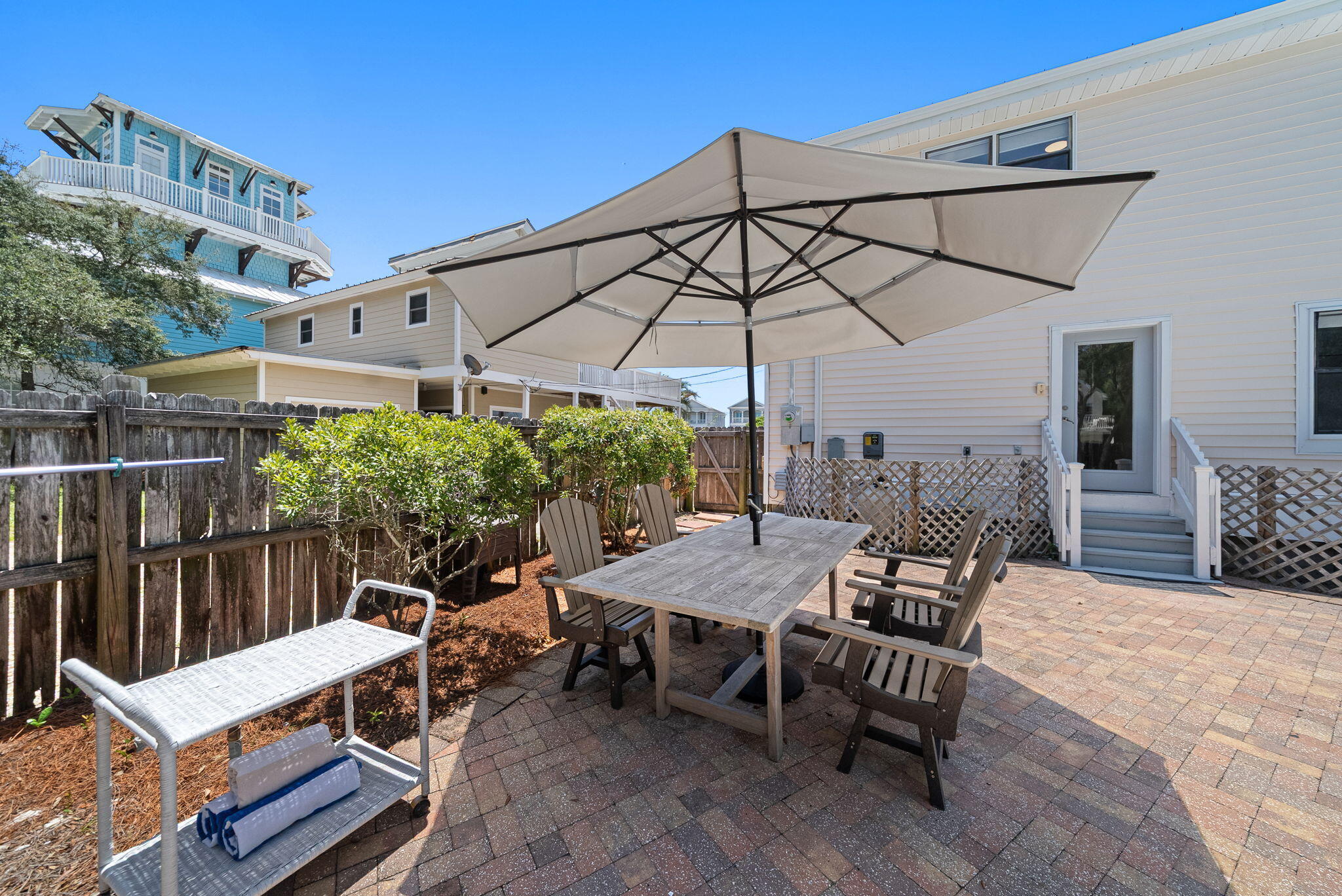 8009 East County Highway 30A Inlet Beach, FL 32461 - Photo 48 of 53 a view of a roof deck with table and chairs under an umbrella