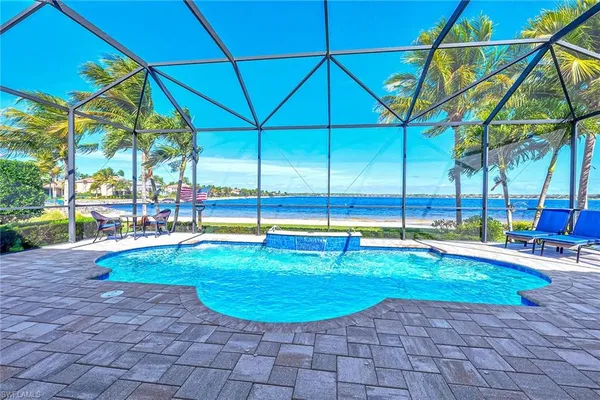 a view of a backyard with swimming pool