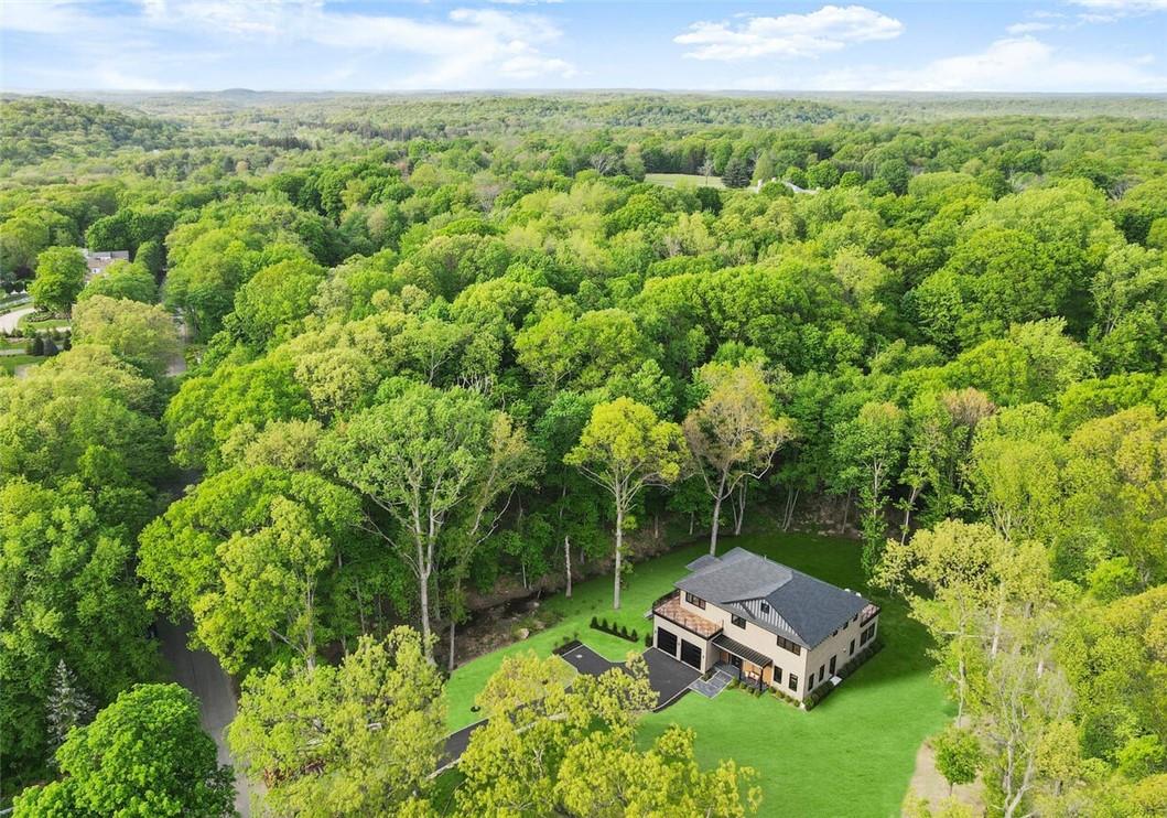 a backyard of a house with lots of green space and garden
