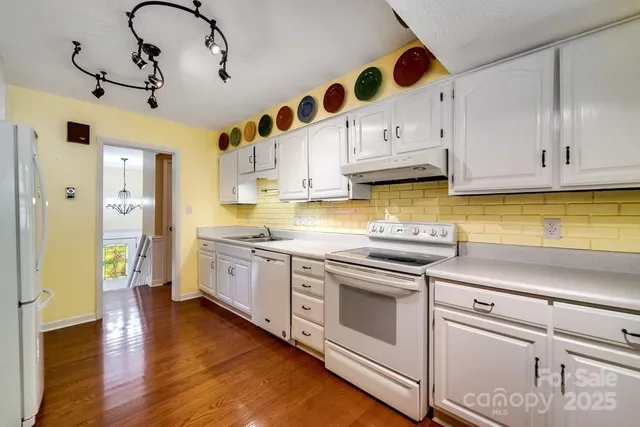 a kitchen with stainless steel appliances granite countertop a sink and cabinets