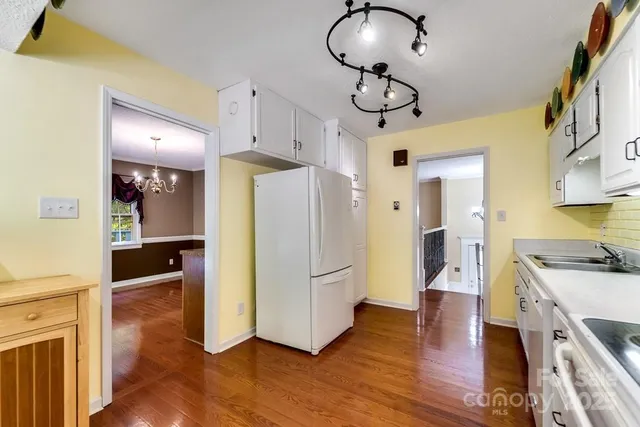 a kitchen view with stainless steel appliances a refrigerator and a stove