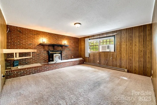 a view of a livingroom with wooden floor and furniture