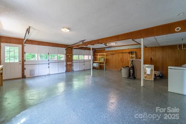 a view of a livingroom with furniture and floor to ceiling window