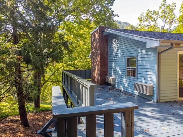 a view of a house with a tree front of house