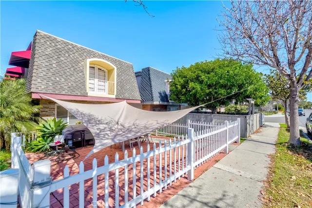 a view of a house with wooden fence