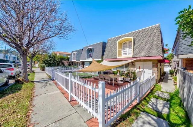 a view of a house with wooden fence