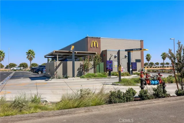a view of a patio with a table and chairs under an umbrella