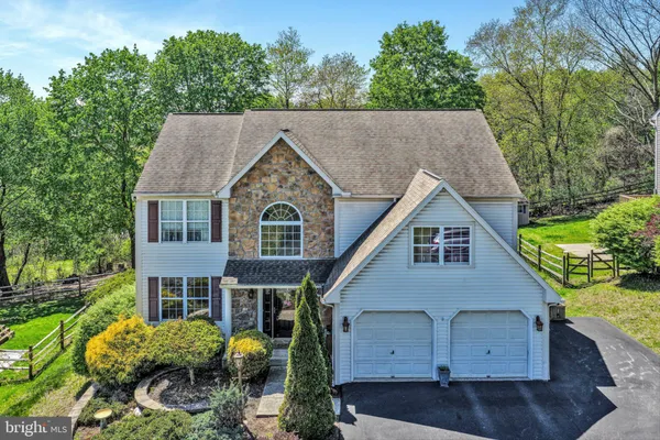 a aerial view of a house next to a yard