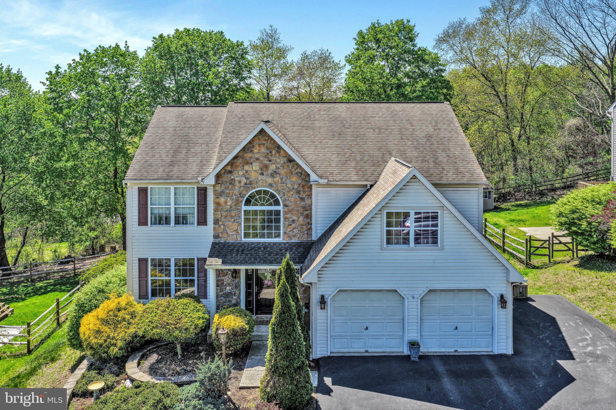 a aerial view of a house next to a yard
